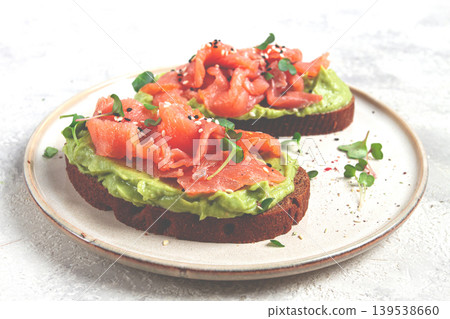 breakfast, Sandwiches with smoked salmon and avocado, on dark rye bread, with microgreens, on a marble table, homemade, no people, breakfast, Sandwiches with smoked salmon and avocado, on dark rye bread, with microgreens, on a marble table, homemade, no people, 139538660
