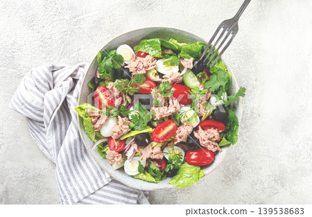 salad with canned tuna, vegetable salad with quail eggs, lettuce and romaine leaves, red onion, cherry tomatoes, olives, keto food, healthy eating, 139538683