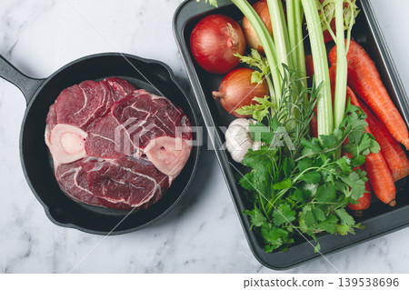 knuckle on the bone, raw meat for ossobuco, in a cast-iron pan, baking sheet with vegetables, top view, no people, knuckle on the bone, raw meat for ossobuco, in a cast-iron pan, baking sheet with vegetables, top view, no people, 139538696