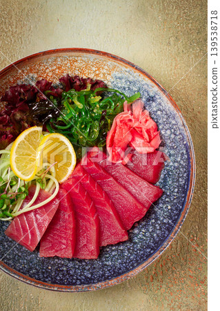 tuna sashimi with daikon and wakame salad, pickled ginger, in a bowl, 139538718