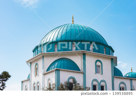 Turquoise dome of a mosque building against blue sky 139538895