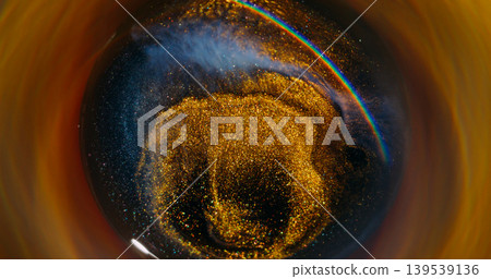 Blur glitter wave. Splatter texture. Defocused golden neon blue color paint swirl sparkling rainbow circling on abstract background. Blur glitter wave. Splatter texture. Defocused golden neon blue color paint swirl sparkling rainbow circling on abstract background. 139539136