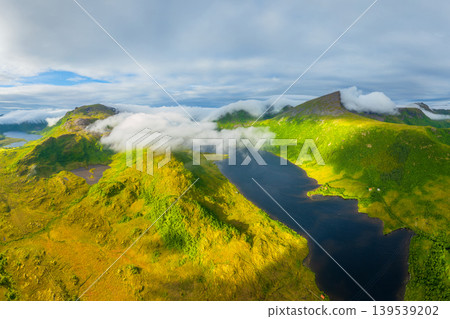 Aerial view of misty mountains and fjords in Lofoten, Norway. Aerial view of misty mountains and fjords in Lofoten, Norway. 139539202