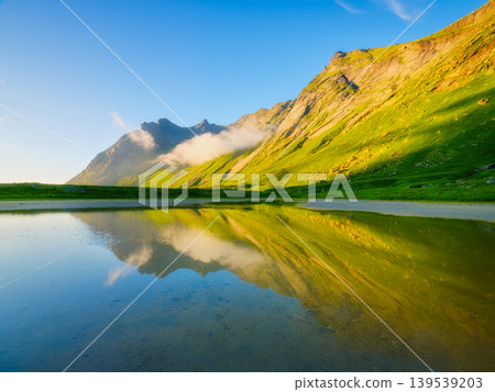 Norwegian arctic fjord at midnight sun. Lofoten Islands, Norway. Norwegian arctic fjord at midnight sun. Lofoten Islands, Norway. 139539203