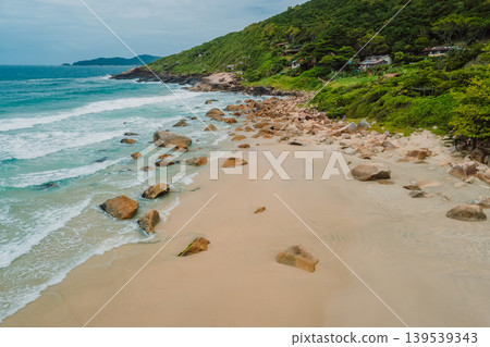 Beach, mountains and blue ocean with waves in Brasil. Drone view Beach, mountains and blue ocean with waves in Brasil. Drone view 139539343