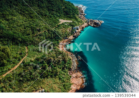 Drone view of granite coastline with blue ocean in Brazil. Drone view of granite coastline with blue ocean in Brazil. 139539344