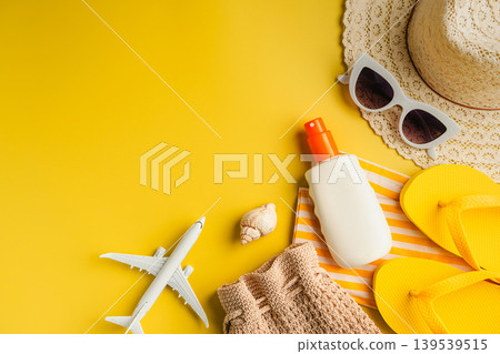 Summer holiday flat lay yellow background. Beach travel accessories for vacation. Airplane, sunglasses, sun hat, sunscreen. Copy space Summer holiday flat lay yellow background. Beach travel accessories for vacation. Airplane, sunglasses, sun hat, sunscreen. Copy space 139539515