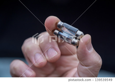 Halogen car new and old lamp bulb. Male hand holding car parts 139539549