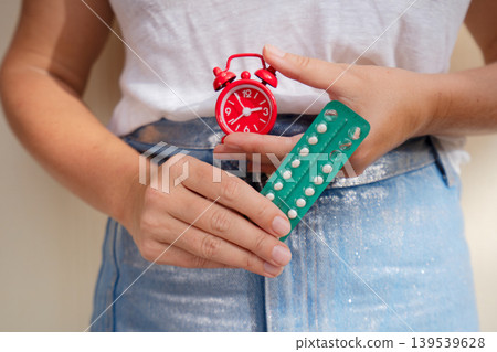 woman holding 21 day oral contraceptive pills, birth control and pregnancy planning woman holding 21 day oral contraceptive pills, birth control and pregnancy planning 139539628