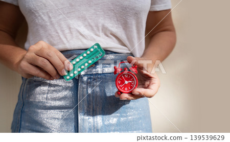woman holding 21 day oral contraceptive pills, birth control and pregnancy planning woman holding 21 day oral contraceptive pills, birth control and pregnancy planning 139539629