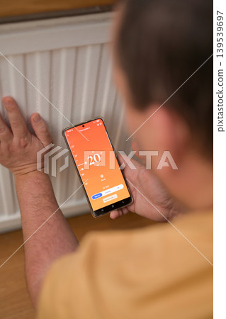 Smartphone connecting to heating system. Remote home control system on a smartphone. smart home 139539697