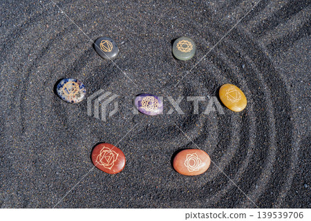 Healing crystals on black sand background Healing crystals on black sand background 139539706