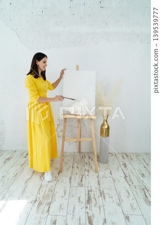 A Joyful Artist Proudly Showcasing Their Colorful Paint Brushes in a Bright and Inspiring Studio Environment A Joyful Artist Proudly Showcasing Their Colorful Paint Brushes in a Bright and Inspiring Studio Environment 139539777