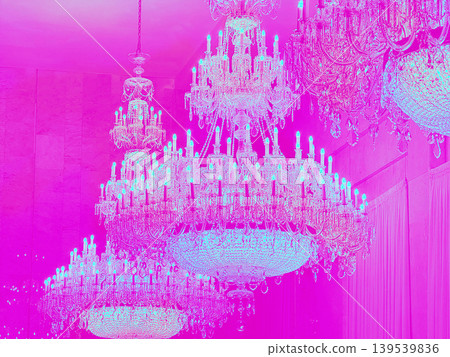 Elegant crystal chandeliers illuminated in vibrant pink hues, creating a luxurious ambiance in a grand space, showcasing intricate designs and sparkling details Elegant crystal chandeliers illuminated in vibrant pink hues, creating a luxurious ambiance in a grand space, showcasing intricate designs and sparkling details 139539836