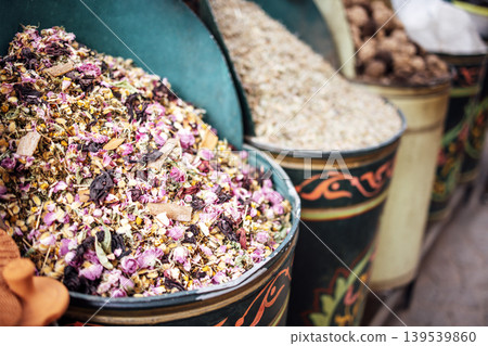 Colorful assortment of dried herbs and flowers in decorative containers, showcasing vibrant textures and natural beauty, perfect for culinary or aromatic uses in various applications 139539860