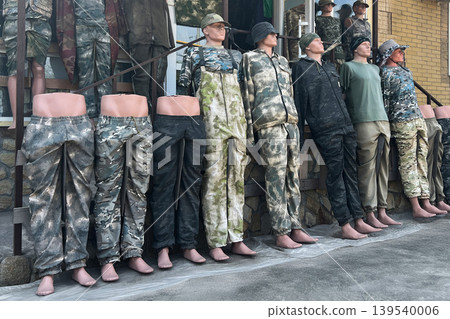 Military camouflage mannequins standing outside tactical clothing store urban marketplace display Military camouflage mannequins standing outside tactical clothing store urban marketplace display 139540006