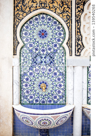 Ornate fountain featuring intricate tile work in vibrant colors, showcasing geometric patterns and traditional design elements, creating a captivating cultural ambiance 139540268
