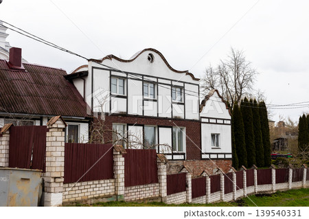 Quiet suburban residence. Traditional two story home featuring fence and mature trees Quiet suburban residence. Traditional two story home featuring fence and mature trees 139540331