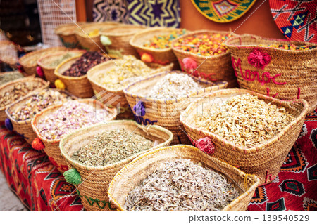 Colorful assortment of spices displayed in woven baskets on a vibrant market table, showcasing diverse textures and natural ingredients for culinary inspiration 139540529
