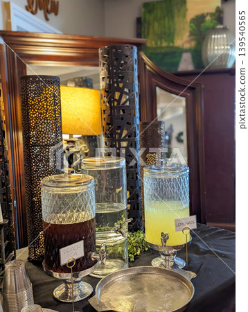 Beverage Station with Glass Drink Dispensers and Refreshments Setup on Table in Event Beverage Station with Glass Drink Dispensers and Refreshments Setup on Table in Event 139540565
