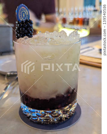 Craft Cocktail with Crushed Ice and Berry Infusion Garnished with Fresh Blackberries Craft Cocktail with Crushed Ice and Berry Infusion Garnished with Fresh Blackberries 139540586