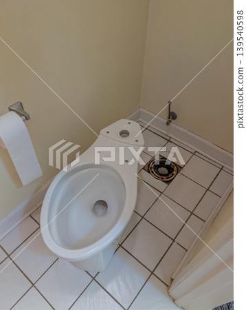 Bathroom Toilet Removed Showing Floor Drain and Plumbing Opening Bathroom Toilet Removed Showing Floor Drain and Plumbing Opening 139540598