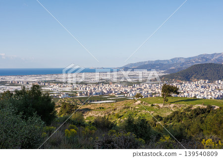 Coastal city with vast greenhouse fields and Mediterranean mountains Coastal city with vast greenhouse fields and Mediterranean mountains 139540809
