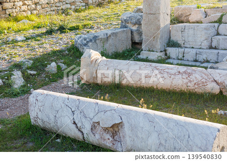 Ancient marble columns lying on grassy ground at historical ruins site Ancient marble columns lying on grassy ground at historical ruins site 139540830