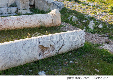 Fallen white marble columns lying on grassy ground at archaeological Fallen white marble columns lying on grassy ground at archaeological 139540832