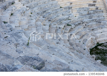 Stone seating rows of an ancient Greco-Roman amphitheater in ruin Stone seating rows of an ancient Greco-Roman amphitheater in ruin 139540846