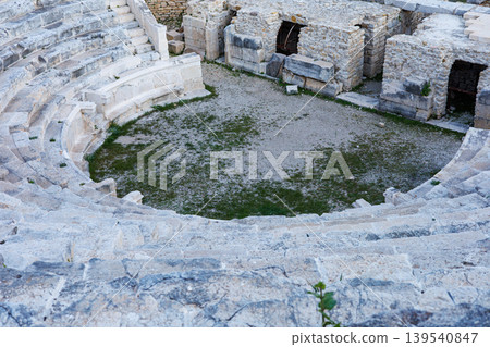 Ancient Roman amphitheater ruins with weathered stone seating Ancient Roman amphitheater ruins with weathered stone seating 139540847