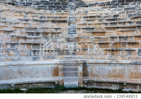 Ancient Roman stone theater seating with central stairs and weathered Ancient Roman stone theater seating with central stairs and weathered 139540851
