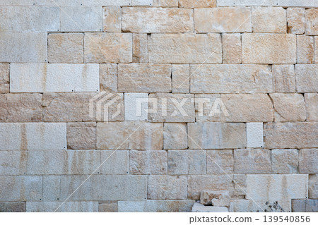 Natural stone wall texture with rectangular blocks in warm earth tones Natural stone wall texture with rectangular blocks in warm earth tones 139540856