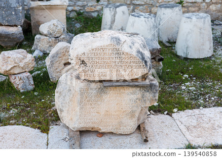 Ancient inscribed stone blocks resting on wooden supports Ancient inscribed stone blocks resting on wooden supports 139540858