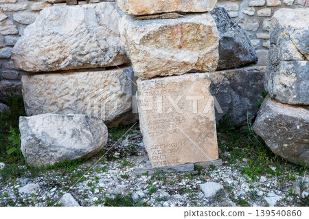 Ancient stone block with carved Greek inscription in outdoor Ancient stone block with carved Greek inscription in outdoor 139540860