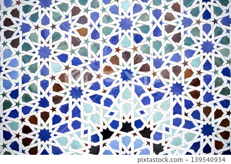Intricate geometric pattern featuring blue, green, and brown tiles arranged in a stunning mosaic design, showcasing artistic craftsmanship and cultural heritage in vibrant colors 139540934