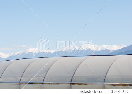 Greenhouse against snow covered mountains Greenhouse against snow covered mountains 139541292