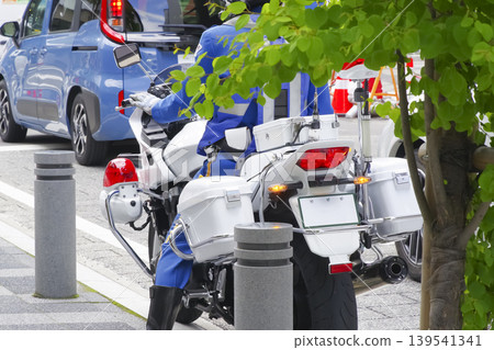 Motorcycle police officers waiting on the side of the road Motorcycle police officers waiting on the side of the road 139541341