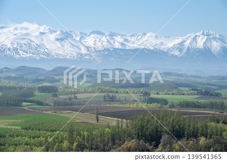 A view of the Tokachi Mountain Range from Biei Town. A view of the Tokachi Mountain Range from Biei Town. 139541365