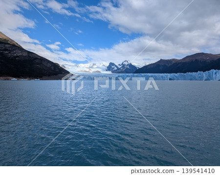 A panorama of the Andes, the Perito Moreno Glacier, and the surface of a lake in Santa Cruz Province, Argentina, during cloudy weather. Patagonia. A panorama of the Andes, the Perito Moreno Glacier, and the surface of a lake in Santa Cruz Province, Argentina, during cloudy weather. Patagonia. 139541410