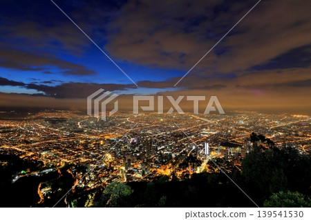The night view of Bogotá, one of South America's largest cities: a carpet of lights and main roads seen from a hilltop. 139541530