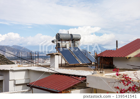 Solar water heating system on a mediterranean house roof Solar water heating system on a mediterranean house roof 139541541