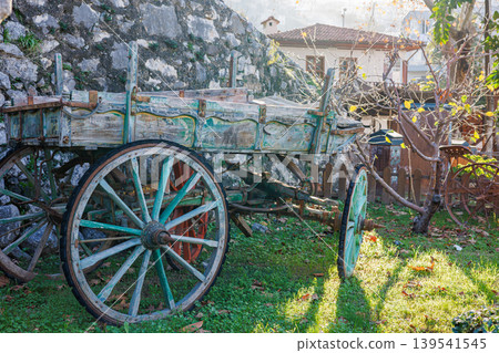 Old rustic wooden farm wagon parked in a garden Old rustic wooden farm wagon parked in a garden 139541545