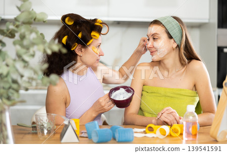 Applying mask to woman's face with brush 139541591
