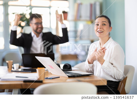 Man and girl office employees is genuinely happy and elated Man and girl office employees is genuinely happy and elated 139541637