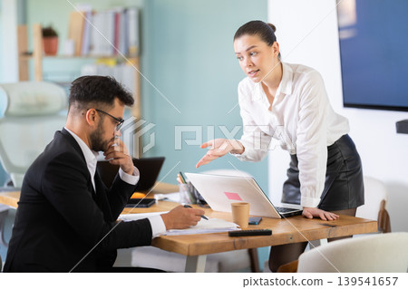 Colleagues business partners at office discuss financial data project documents paperwork 139541657