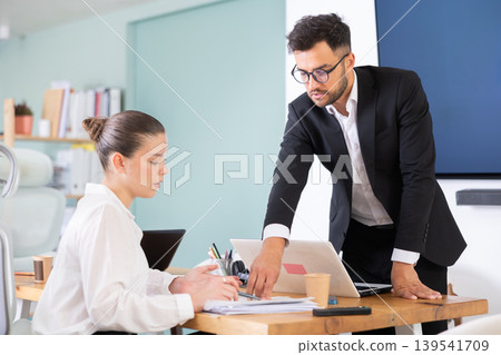 Guy and girl office employees read and process documents Guy and girl office employees read and process documents 139541709
