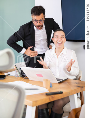 Man and a woman work in an office and are emotionally joy about the success in a new project Man and a woman work in an office and are emotionally joy about the success in a new project 139541710