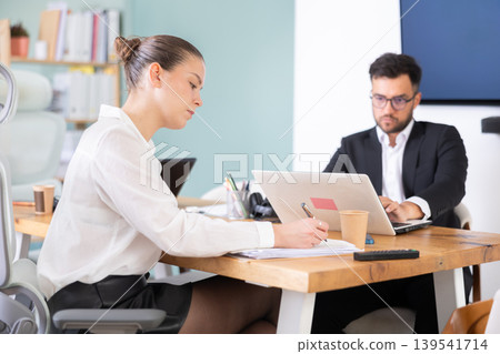 Man and woman working in office Man and woman working in office 139541714