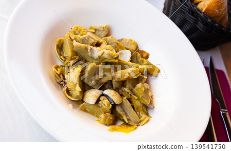 Plate of tasty cooked artichokes with sea shellfish Plate of tasty cooked artichokes with sea shellfish 139541750
